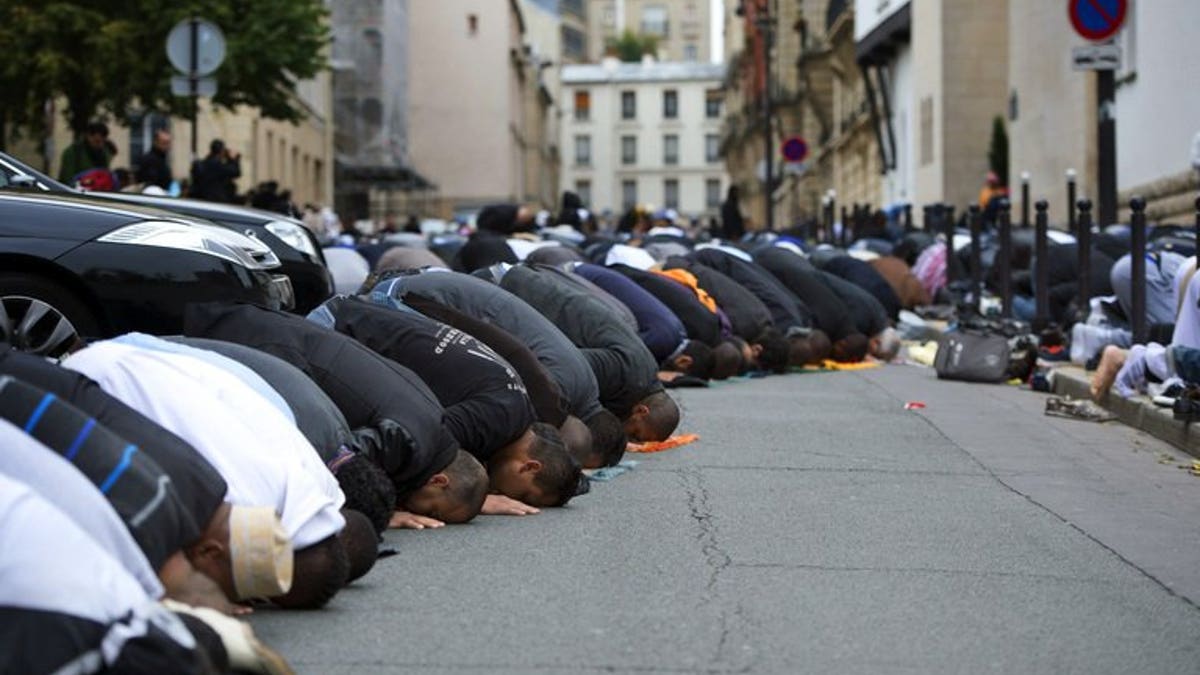 Muslims pray outside the Grande Mosque of Paris on the first day of Eid al-Adha on October 26, 2012. The European Parliament on Tuesday lifted immunity for French National Front leader Marine Le Pen, opening the way for her to face charges for likening the sight of Muslims praying in the street to Nazi occupation during World War II.