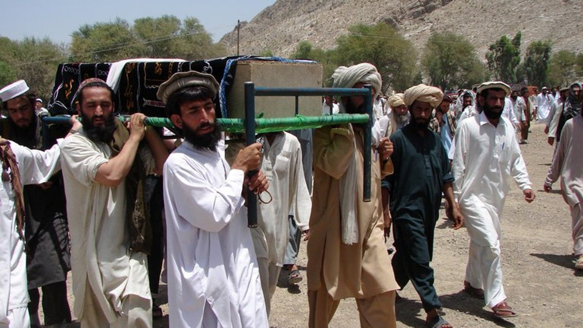 Pakistani tribesmen carry the coffin of a person allegedly killed in a US drone attack, in Miranshah, on June 16, 2011. A US drone attack struck a compound of the Al-Qaeda-linked Haqqani network in Miranshah, killing at least 17 militants.