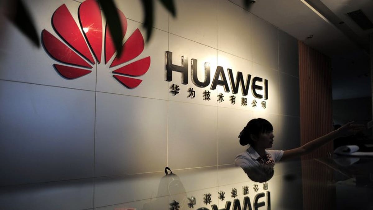 A receptionist is seen behind the counter of a Huawei office in Wuhan, central China's Hubei province, on October 8, 2012.