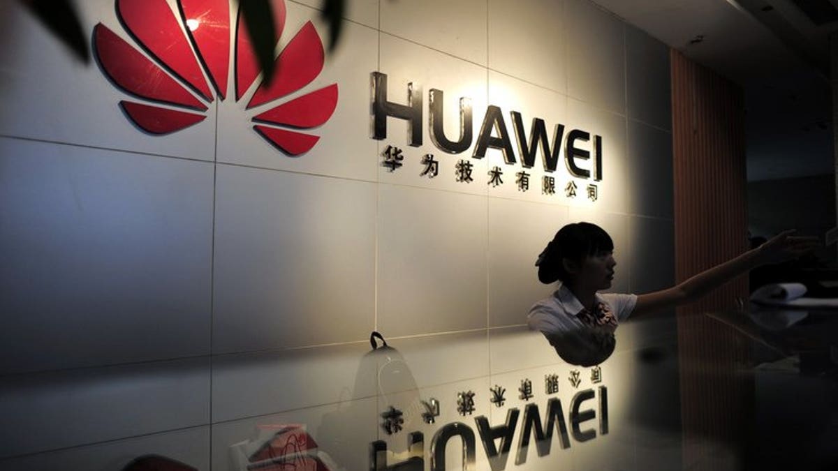 A receptionist is seen behind the counter of a Huawei office in Wuhan, central China's Hubei province, on October 8, 2012.