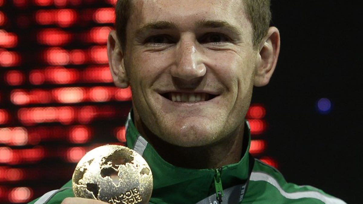 Gold medalist South Africa's Cameron Van Der Burgh poses on the podium with his medal during the award ceremony of the men's 50m breaststroke event in the FINA World Championships at Palau Sant Jordi in Barcelona, on July 31, 2013.