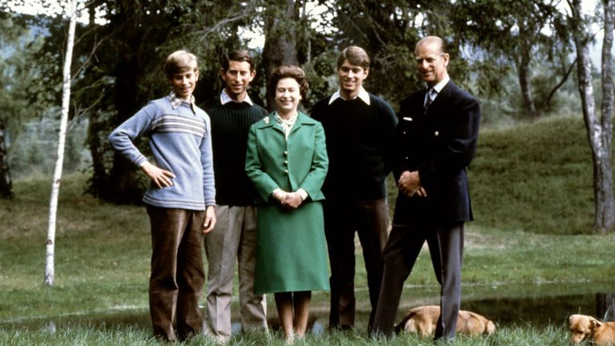 Queen Elizabeth and the Duke of Edinburgh (R) pose with their three sons, Charles, Edward (L), Andrew (2ndR) and the royal corgies in Balmoral Castle, Scotland, November 20, 1979.
