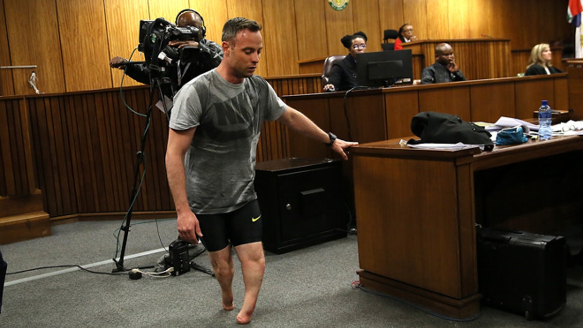 Oscar Pistorius walks on his stumps during argument in mitigation of sentence by his defense attorney Barry Roux in the High Court in Pretoria, South Africa, Wednesday, June 15, 2016. An appeals court found Pistorius guilty of murder and not a lesser charge of culpable homicide for the shooting death of his girlfriend Reeva Steenkamp. (AP Photo/Alon Skuy, Pool via AP)