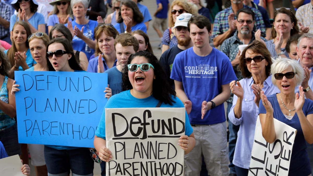 abortion protesters holding signs