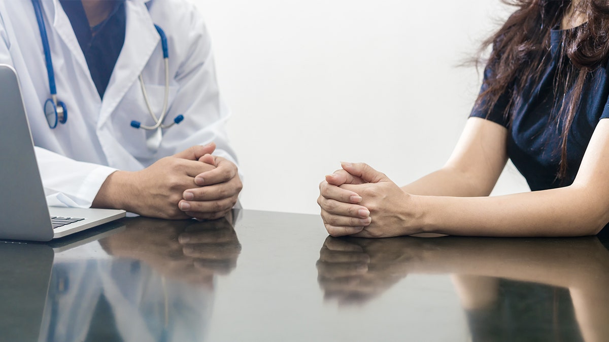 woman talking to doctor istock