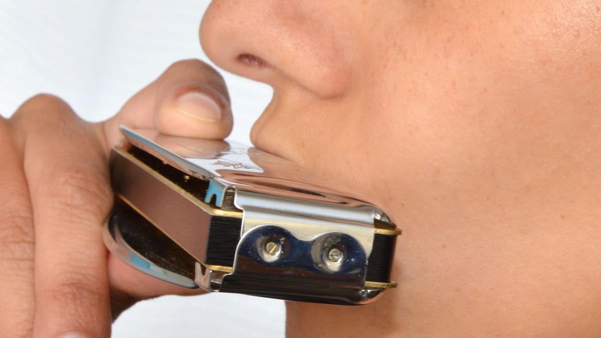 playing a harmonica istock large