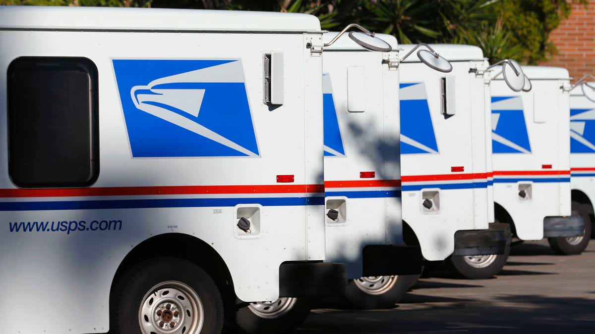 Nov. 13, 2013: U.S. postal service trucks sit parked at the post office.