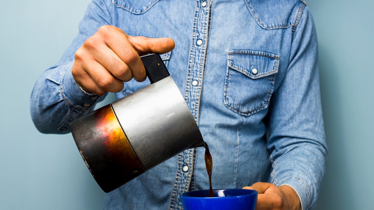 pouring a cup of coffee istock