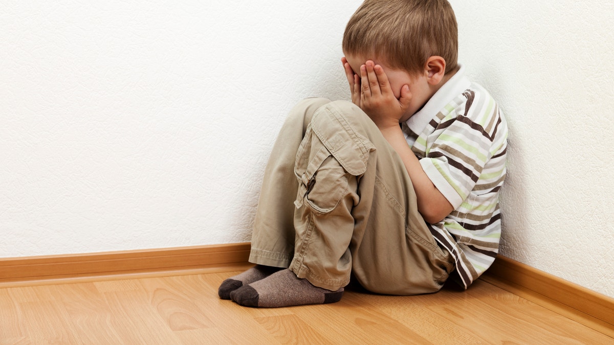 Little child boy wall corner punishment sitting