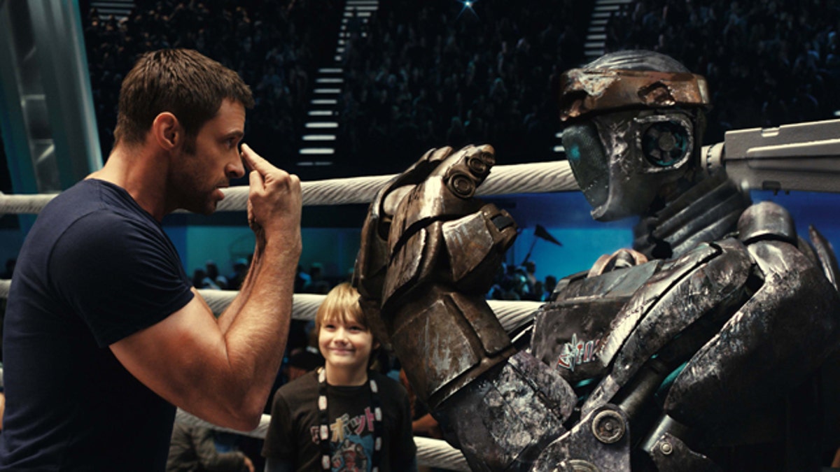 In this image released by Disney/DreamWorks II, Hugh Jackman, left, and Dakota Goyo are shown in a scene from 