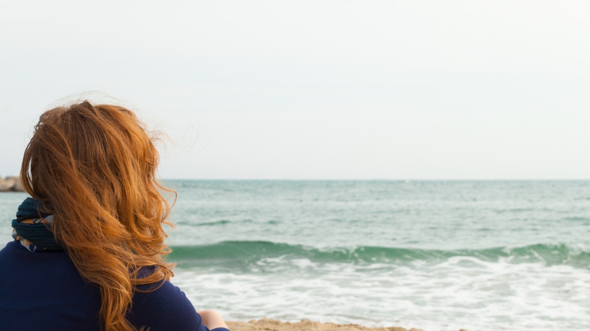 redhead at the beach istock