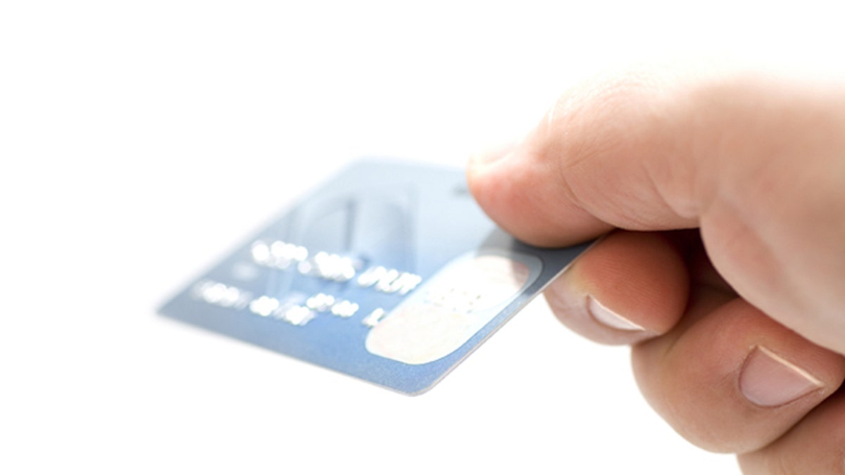 Hand holding credit cards. Small DOF
