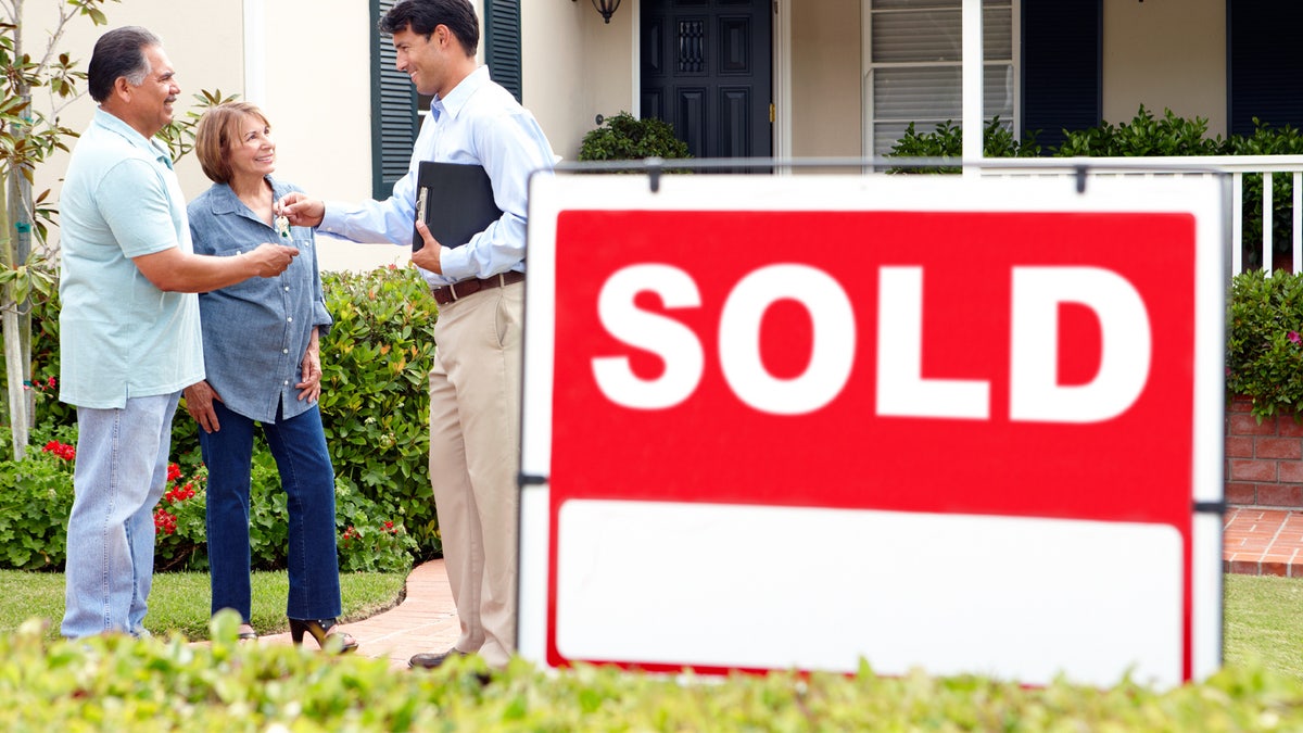 Senior Hispanic couple buying new home