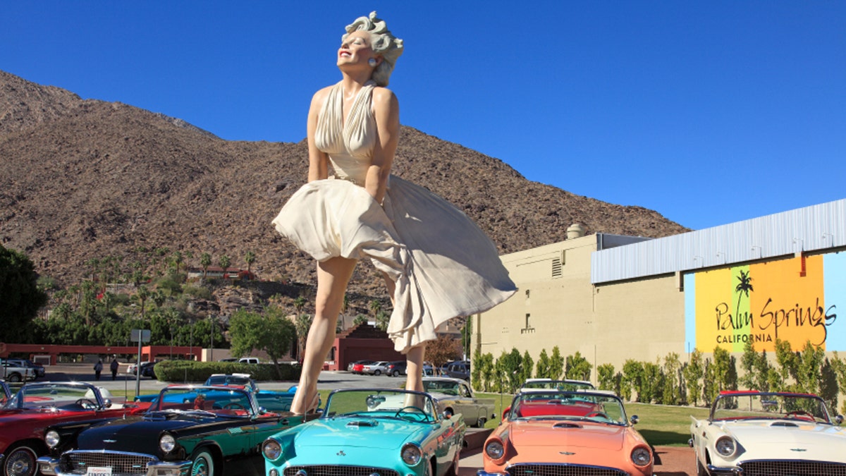 Public Square downtown Palm Springs with Marilyn Monroe scupture and early model convertibleThunderbirds. Brilliant blue Palm Springs Sky in the background. All from the same era. Marilyn is the most popular tourist attraction in the town.
