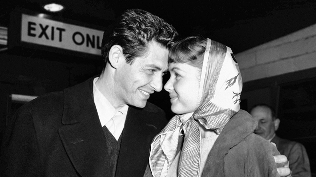 Singer Eddie Fisher and his fiancÈe, actress Debbie Reynolds, have eyes only for each other at Idlewild Airport, April 19, 1955 in New York on arriving by plane from England. Eddie performed at the London Palladium and both he and Debbie appeared in a command performance for Queen Elizabeth II. They were accompanied on their trip by Miss Reynoldsí mother, Mrs. Maxene Reynolds of Burbank, Calif. (AP Photo)