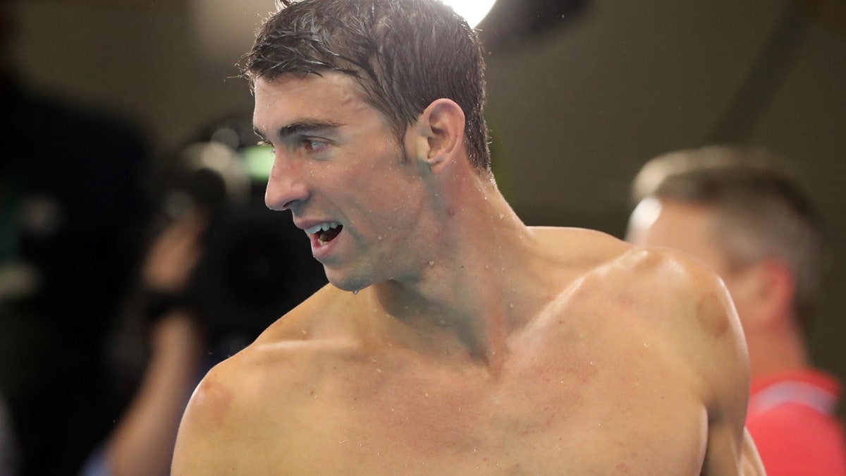 United States' Michael Phelps leaves the pool deck after his team won gold in the men's 4 x 100-meter medley relay final during the swimming competitions at the 2016 Summer Olympics, Saturday, Aug. 13, 2016, in Rio de Janeiro, Brazil. (AP Photo/Lee Jin-man)