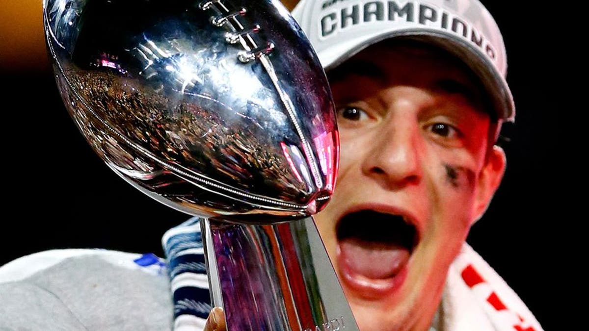 GLENDALE, AZ - FEBRUARY 01: Rob Gronkowski #87 of the New England Patriots celebrates while holding up the Vince Lombardi Trophy after defeating the Seattle Seahawks during Super Bowl XLIX at University of Phoenix Stadium on February 1, 2015 in Glendale, Arizona. The Patriots defeated the Seahawks 28-24. (Photo by Kevin C. Cox/Getty Images)
