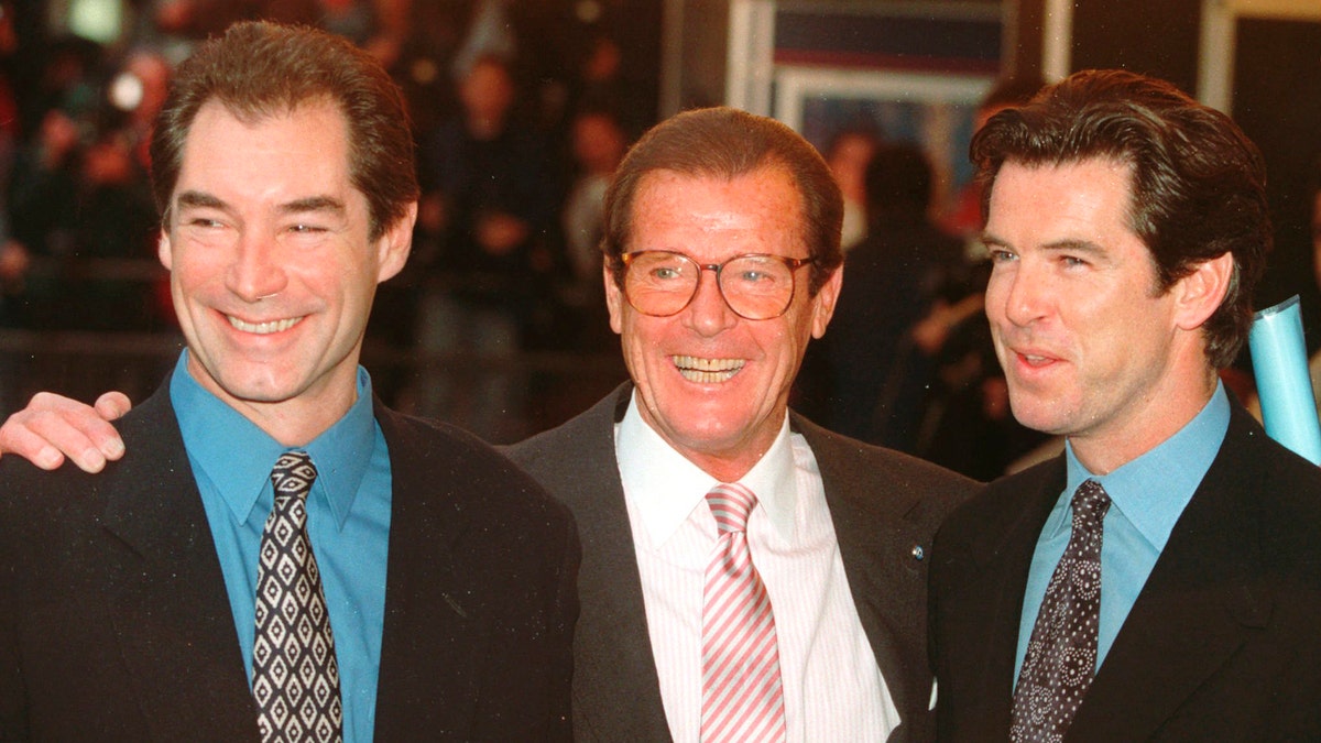 File - In this Sunday, Nov. 17, 1996 file photo, three of the actors who played James Bond, Timothy Dalton left, Roger Moore, center, and Pierce Brosnan, at a London cinema to celebrate the life of Albert R. 