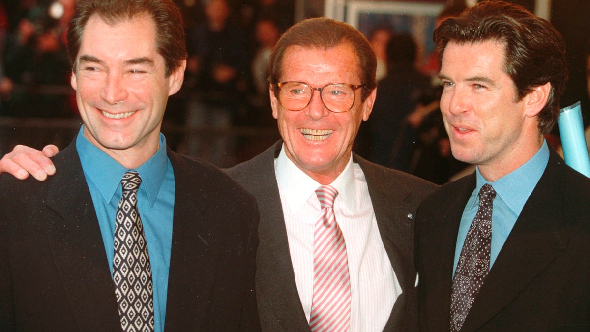 File - In this Sunday, Nov. 17, 1996 file photo, three of the actors who played James Bond, Timothy Dalton left, Roger Moore, center, and Pierce Brosnan, at a London cinema to celebrate the life of Albert R. 