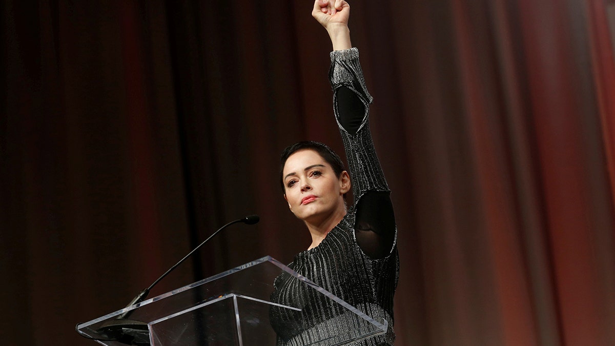 Actor Rose McGowan raises her fist after addressing the audience during the opening session of the three-day Women's Convention at Cobo Center in Detroit, Michigan, U.S., October 27, 2017. REUTERS/Rebecca Cook TPX IMAGES OF THE DAY - RC1A6DD22B20