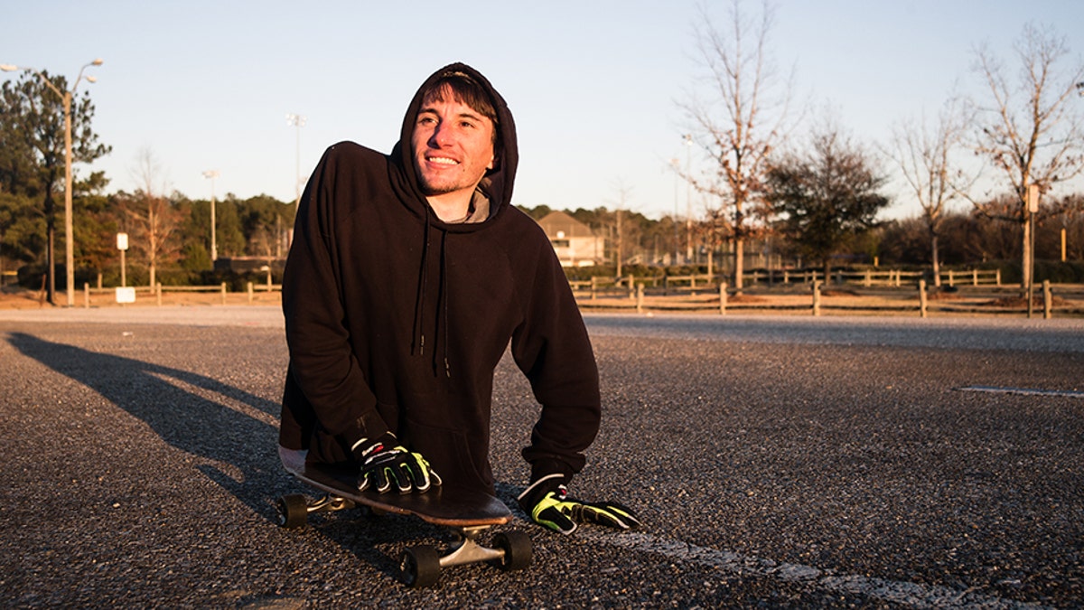 Man born with rare spine condition uses hands skateboard to get