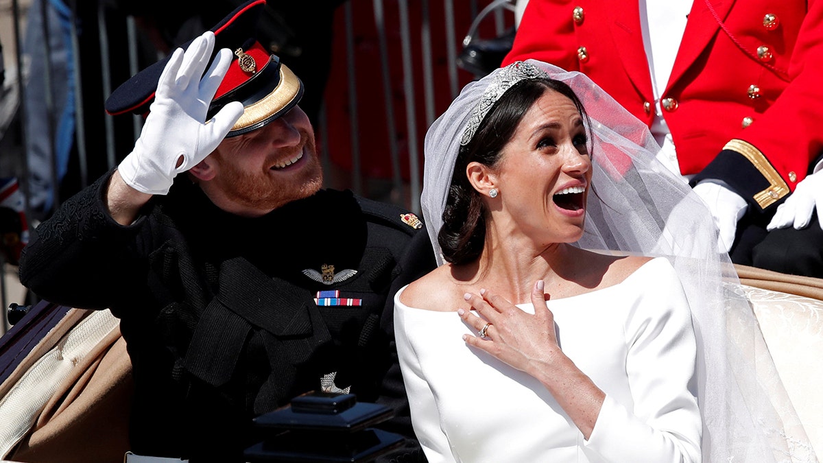 Britainâs Prince Harry and his wife Meghan ride a horse-drawn carriage after their wedding ceremony at St Georgeâs Chapel in Windsor Castle in Windsor, Britain, May 19, 2018. Benoit Tessier: "After installing my equipment, I had a long wait before seeing the couple. After six hours, they finally passed by. Meghan seemed very excited." REUTERS/Benoit Tessier/File photo SEARCH "WEDDING PHOTOGRAPHS" FOR THIS STORY. SEARCH "WIDER IMAGE" FOR ALL STORIES. TPX IMAGES OF THE DAY - RC1B0322B330