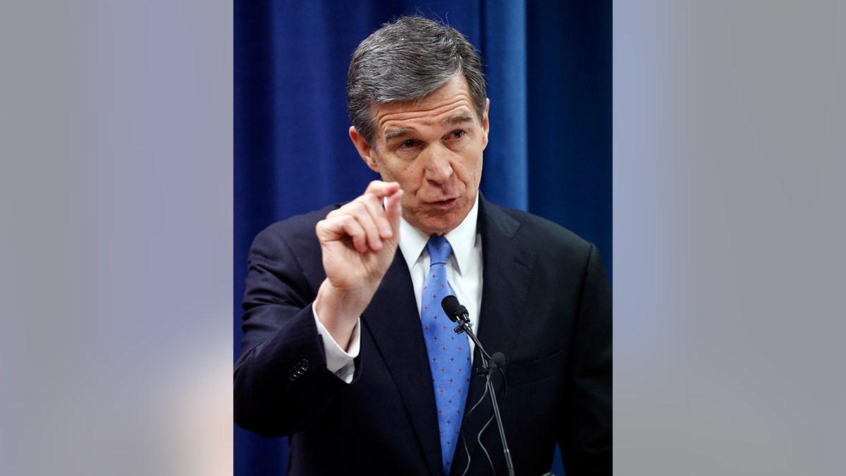 North Carolina's Governor-elect Roy Cooper holds a press conference to criticize efforts by Republicans to cut the power of the governor's office during the special session of the General Assembly that is going on a few blocks away on Thursday, Dec. 15, 2016, in Raleigh, N.C. (Chris Seward/The News & Observer via AP)