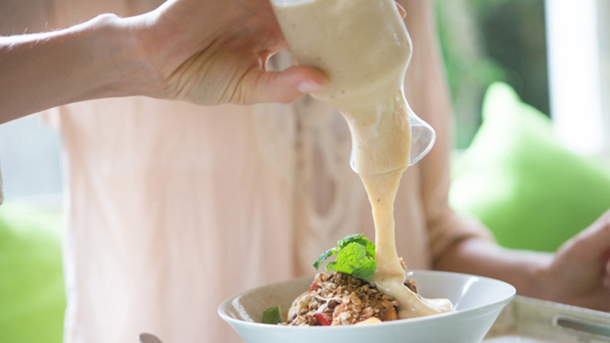 Woman pouring cream sauce