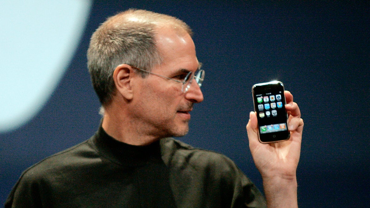 Apple Computer Inc. Chief Executive Officer Steve Jobs holds the new iPhone in San Francisco, California January 9, 2007. Apple unveiled an eagerly-anticipated iPod mobile phone with a touch-screen on Tuesday, priced at $599 for 8 gigabytes of memory, pushing the company's shares up as much as 8.5 percent. Jobs said the iPhone, which also will be available in a 4-gigabyte model for $499, will ship in June in the United States. The phones will be available in Europe in the fourth quarter and in Asia in 2008. REUTERS/Kimberly White (UNITED STATES) FOR BEST QUALITY IMAGE SEE: GM1E7AE0B8F01 - RTR1L0YV