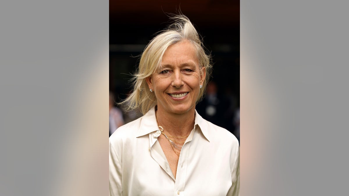 Martina Navratilova smiles after meeting Britain's Queen Elizabeth at the Queen attends the Wimbledon Lawn Tennis Championships at the All England Lawn Tennis and Croquet Club in London June 24, 2010.REUTERS/Pool/Oli Scarf (BRITAIN - Tags: SPORT TENNIS ROYALS ENTERTAINMENT) - RTR2FN8W