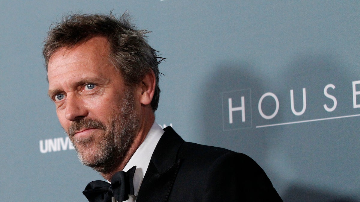Cast member Hugh Laurie poses as he arrives at the series finale wrap party of the television series 