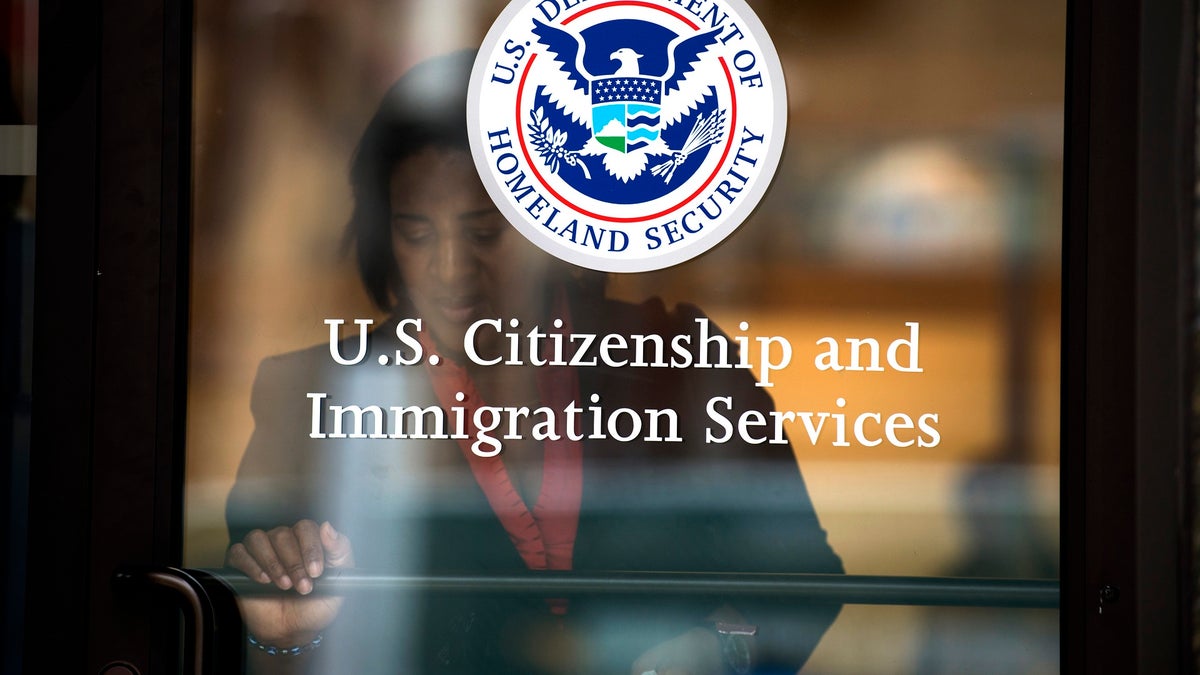 A woman leaves the U.S. Citizenship and Immigration Services offices in New York, August 15, 2012. The U.S. government began accepting applications on Wednesday from young illegal immigrants seeking temporary legal status under relaxed deportation rules announced by the Obama administration in June. REUTERS/Keith Bedford (UNITED STATES - Tags: SOCIETY IMMIGRATION POLITICS) - GM1E88G09N901