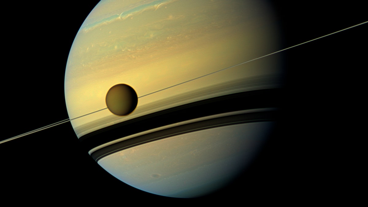 Titan, Saturn's largest moon appears before the planet as it undergoes seasonal changes in this natural color view from NASA's Cassini spacecraft in this handout released by NASA August 29, 2012.  The moon measures 3,200 miles, or 5,150 kilometers, across and is larger than the planet Mercury. Cassini scientists have been watching the moon's south pole since a vortex appeared in its atmosphere in 2012.  REUTERS/ NASA/JPL-Caltech/SSI (UNITED STATES - Tags: SCIENCE TECHNOLOGY) FOR EDITORIAL USE ONLY. NOT FOR SALE FOR MARKETING OR ADVERTISING CAMPAIGNS. THIS IMAGE HAS BEEN SUPPLIED BY A THIRD PARTY. IT IS DISTRIBUTED, EXACTLY AS RECEIVED BY REUTERS, AS A SERVICE TO CLIENTS - RTR3795S