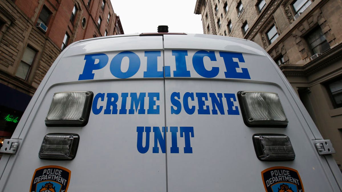 A New York City Police Crime Scene Unit vehicle stands on West 75th street outside an apartment building where two children died in a stabbing, on New York City's upper west side of Manhattan early October 26, 2012. The children's mother returned home to the luxury New York City apartment on Thursday to find two of her young children stabbed to death in the bathtub, and the family's nanny was arrested as the suspect in the killings, police said. REUTERS/Mike Segar (UNITED STATES - Tags: CRIME LAW) - RTR39M8H