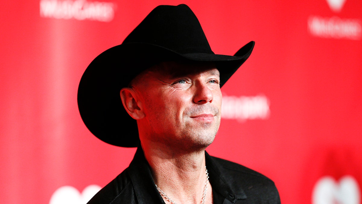 Country singer Kenny Chesney poses at the 2013 MusiCares Person of the Year Tribute and Dinner honoring Bruce Springsteen in Los Angeles February 8, 2013. REUTERS/Danny Moloshok (UNITED STATES - Tags: ENTERTAINMENT) - GM1E929167E01