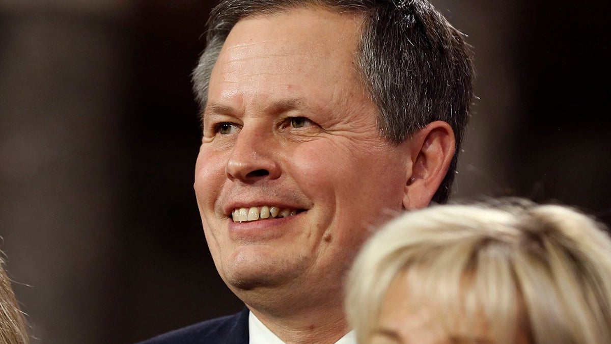 U.S. Senator Steve Daines (R-MT) smiles after he was ceremonially sworn-in by Vice President Joseph Biden in the Old Senate Chamber on Capitol Hill in Washington January 6, 2015.     REUTERS/Larry Downing   (UNITED STATES - Tags: POLITICS HEADSHOT) - GM1EB170DHP01