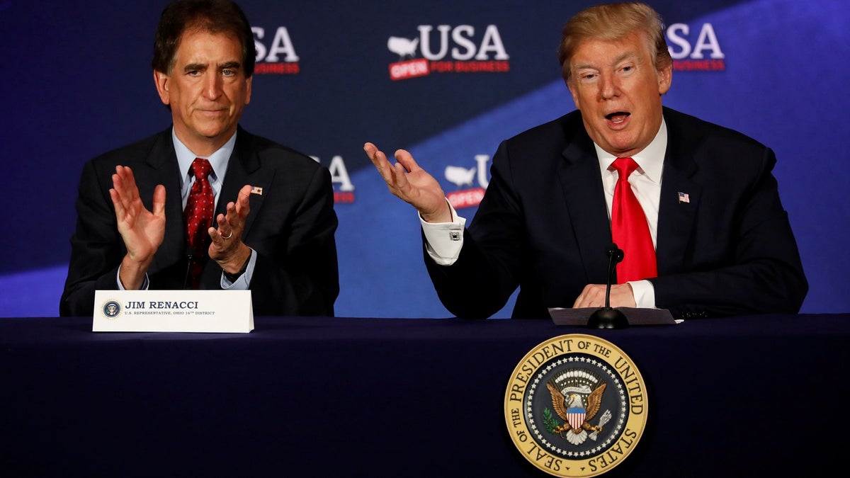 President Donald Trump, accompanied by Rep. Jim Renacci (R-OH), speaks during a roundtable discussion on tax reform at the Cleveland Public Auditorium in Cleveland, Ohio, U.S., May 5, 2018. REUTERS/Aaron P. Bernstein - RC155F9B5980