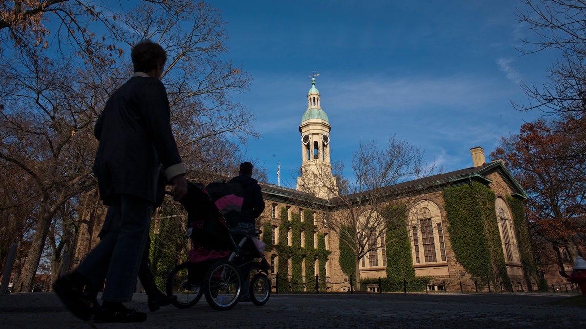 People walk around the Princeton University campus in New Jersey, November 16, 2013. A meningitis vaccine approved for use in Europe and Australia but not in the United States can be imported to try to stop an outbreak of the disease at Princeton University in New Jersey, federal health officials said. The Food and Drug Administration agreed this week to the importation of the vaccine, Bexsero, for potential use on the Ivy League campus, Barbara Reynolds, a spokeswoman for the Centers for Disease Control and Prevention, said on Saturday. REUTERS/Eduardo Munoz (UNITED STATES - Tags: SOCIETY EDUCATION HEALTH) - RTX15GEL