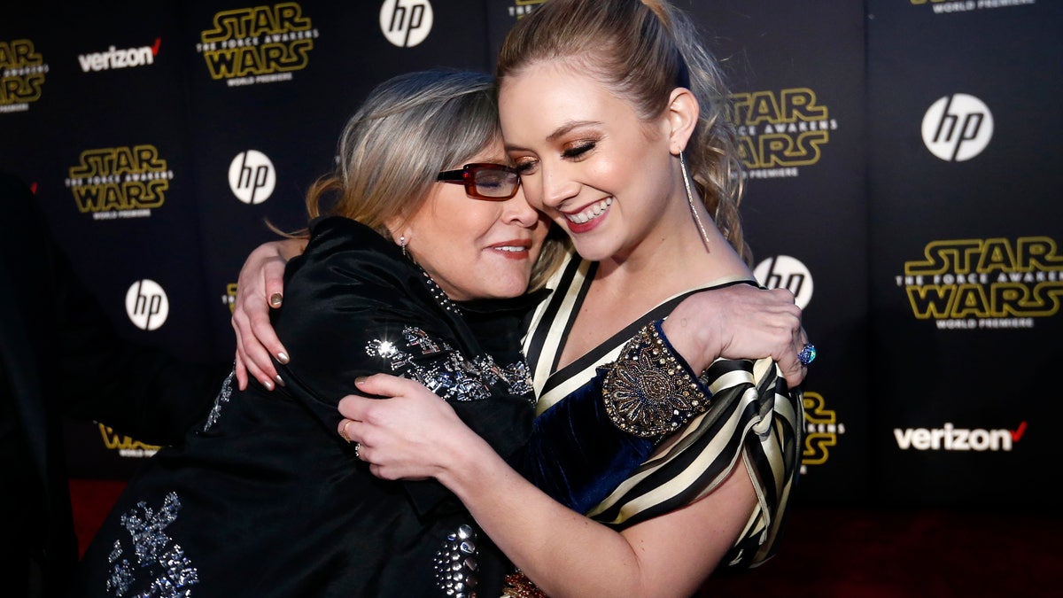 Actresses Carrie Fisher (L) and Billie Lourd embrace as they arrive at the premiere of 
