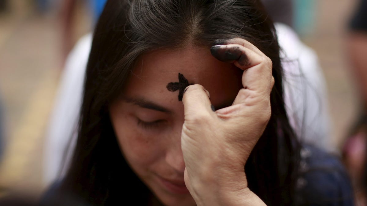 Woman getting ashes on Ash Wednesday