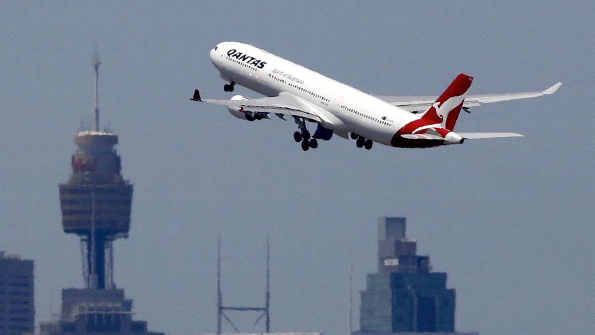 A Qantas Airways Airbus A330-300 jet takes off from Sydney International Airport over the city skyline, December 18, 2015.     REUTERS/Jason Reed/File photo - RTX2R40T
