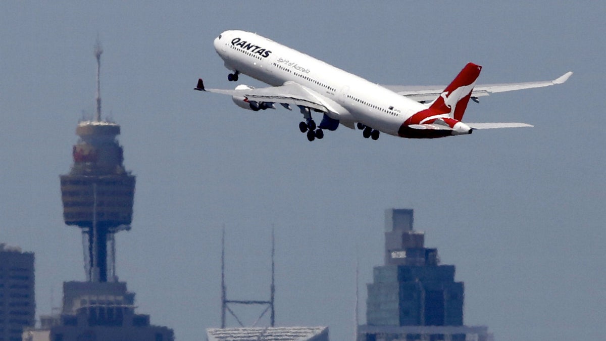 A Qantas Airways Airbus A330-300 jet takes off from Sydney International Airport over the city skyline, December 18, 2015.     REUTERS/Jason Reed/File photo - RTX2R40T