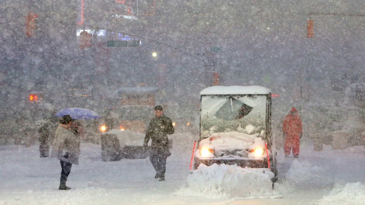 A snowplow drives through Times Square as snow falls in Manhattan, New York, U.S. February 9, 2017.  REUTERS/Andrew Kelly - RTX30B53