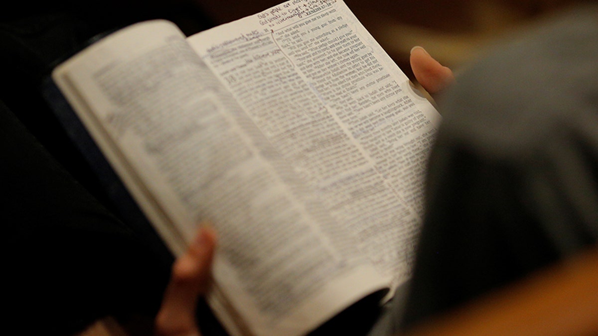 A woman reads her bible before the Exalt Showcase of gospel and Christian music at Central Presbyterian Church at the South by Southwest (SXSW) Music Film Interactive Festival 2017 in Austin, Texas, U.S., March 14, 2017. Picture taken March 14, 2017. REUTERS/Brian Snyder - RC1F4366E3D0