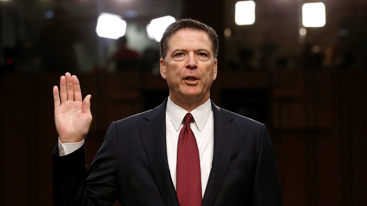 Former FBI Director James Comey is sworn in prior to testifying before a Senate Intelligence Committee hearing on Russia's alleged interference in the 2016 U.S. presidential election on Capitol Hill in Washington, U.S., June 8, 2017. REUTERS/Jonathan Ernst TPX IMAGES OF THE DAY - HP1ED681C71SC