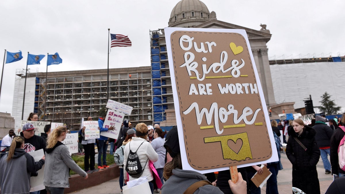 FILE PHOTO: Teachers rally outside the state Capitol for the second day of a teacher walkout to demand higher pay and more funding for education in Oklahoma City, Oklahoma, U.S., April 3, 2018. REUTERS/Nick Oxford/File Photo - RC1CCABB7400