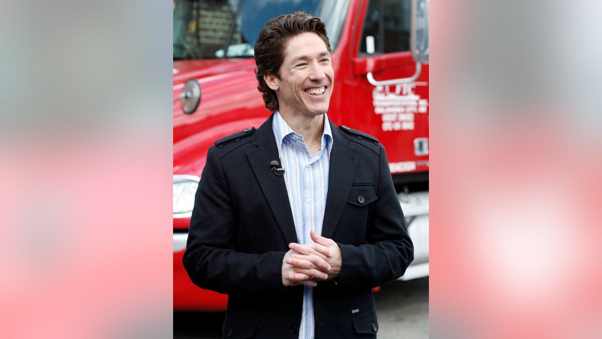 The Rev. Joel Osteen smiles at a food distribution site for Feed The Children in New York April 23, 2009. The distribution site was set up for employees laid off from hotel and restaurant jobs affected by a drop in tourism. REUTERS/Shannon Stapleton (UNITED STATES SOCIETY RELIGION BUSINESS) - RTXEB2Y
