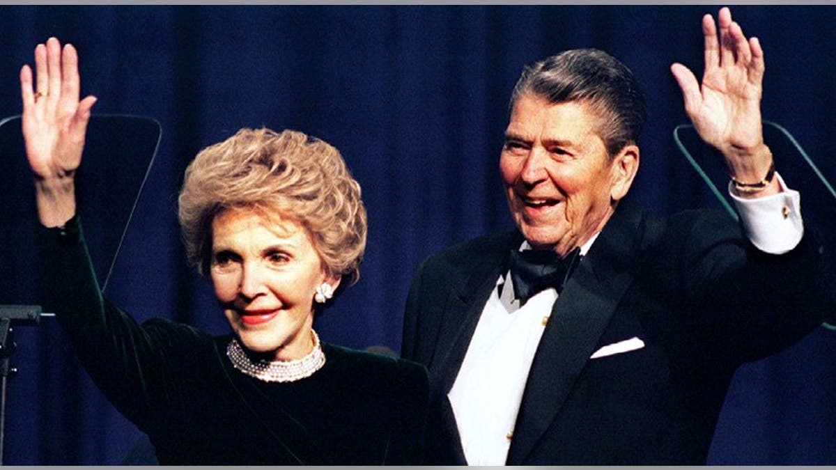 Former US President Ronald Reagan and his wife Nancy wave while attending a gala celebrating his 83rd birthday, February 3 in Washington - RTXFGJD