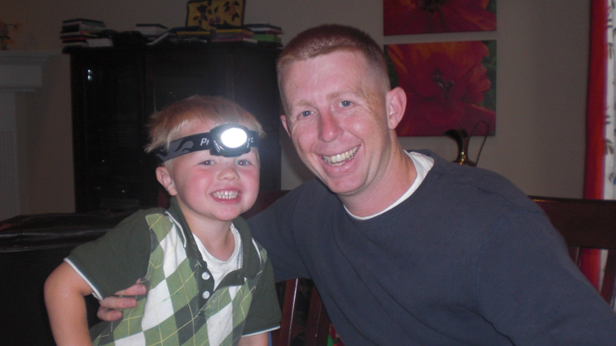 Not forgotten: Army Capt. John Hallett, shown here with son Jackson, is remembered along with other fallen soldiers every time members of the group lace up their sneakers.
