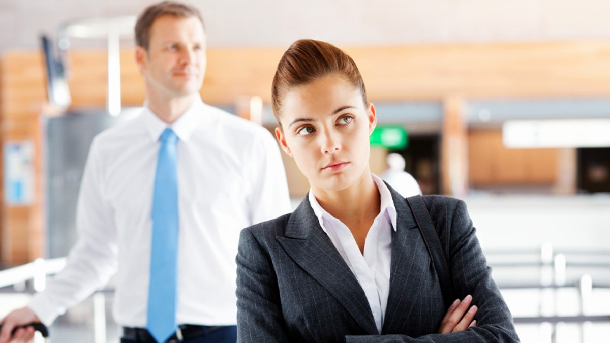 Unhappy Business Woman Waiting At Check-In Desk